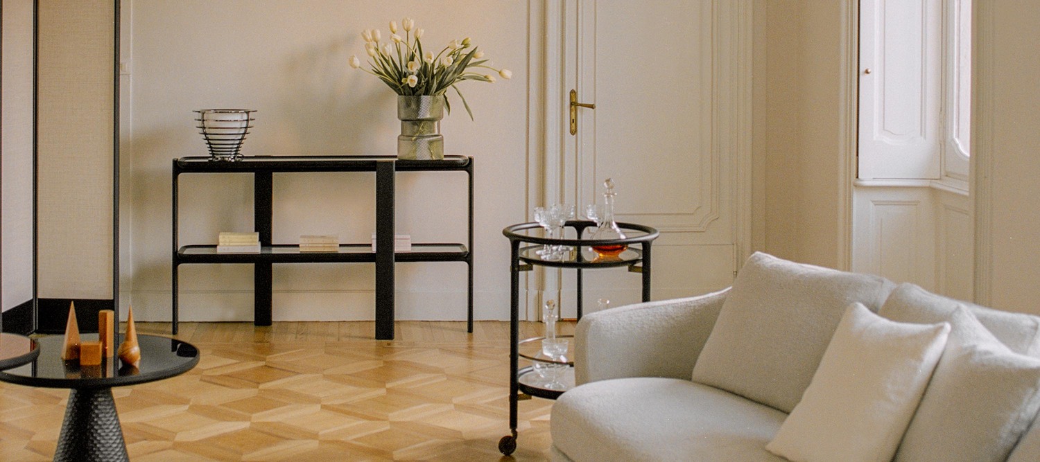 DUO bar trolley by Poltrona Frau with solid ash wood frame, glass top, marble or veneered lower shelf, bronzed brass details, wheels for mobility, contemporary Italian luxury