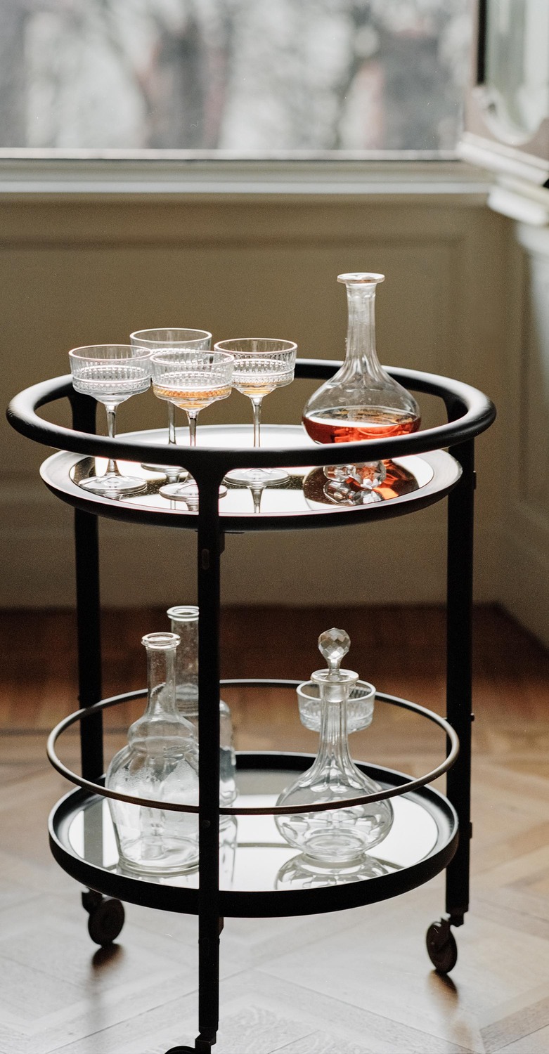 DUO bar trolley by Poltrona Frau with solid ash wood frame, glass top, marble or veneered lower shelf, bronzed brass details, wheels for mobility, contemporary Italian luxury