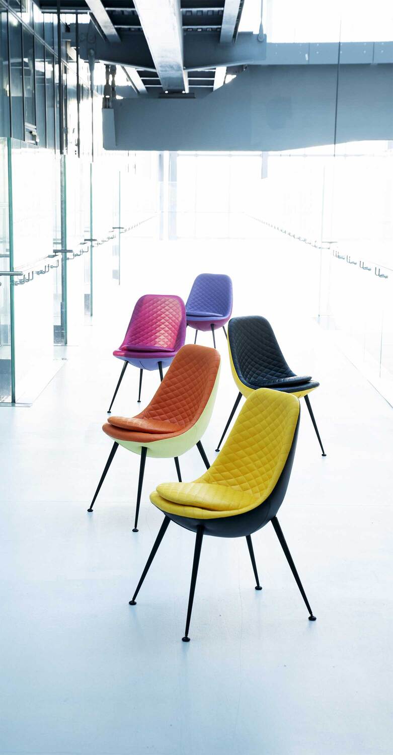 Margherita | 椅子 Poltrona Frau 的 Margherita 椅子,以花瓣为灵感设计,将优雅与舒适相融合,配有锥形金属椅腿和柔软坐垫。